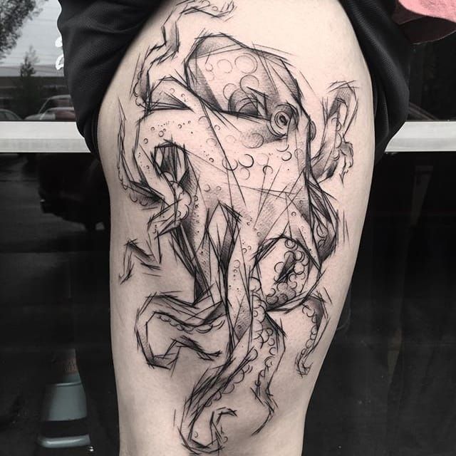 a man's thigh with an octopus tattoo on it