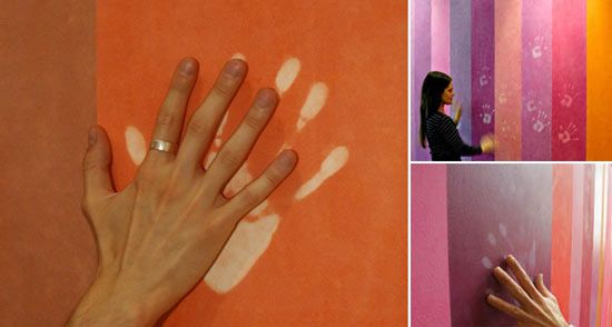 several different pictures of hand prints on the wall and in front of a woman's hand