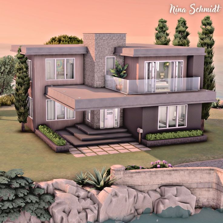 an image of a modern house on the water's edge with trees and rocks surrounding it