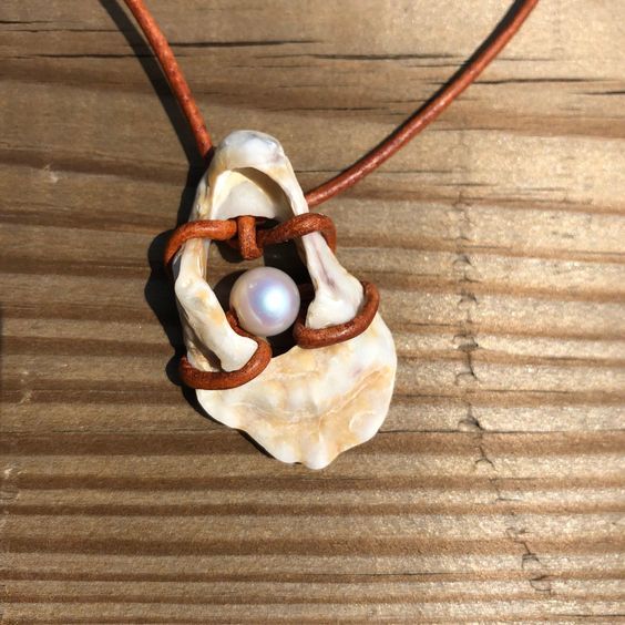 Handpicked seashell from Amelia Island, Florida attached to an adjustable brown leather cord (approximately 20in) with freshwater pearls using the shell's natural hole. Brown Shell Necklace As A Gift, Bohemian Brown Shell As Gift, Broken Shell Jewelry, Handmade Brown Shell As A Gift, Handmade Brown Shell As Gift, Handmade Brown Shell For Gift, Handmade Brown Shell Gift, Seashell Jewelry Diy, Amelia Island Florida