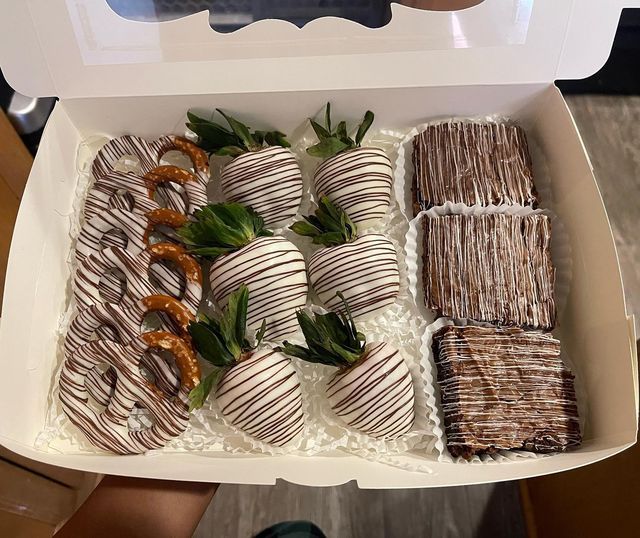 a box filled with chocolate covered strawberries and pretzels