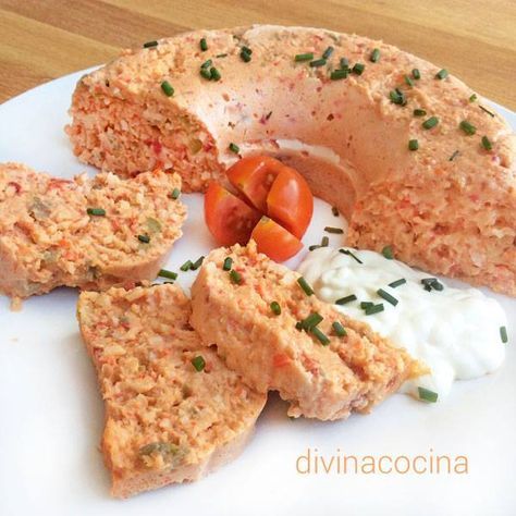 an assortment of food on a white plate with tomatoes and cream cheese, as well as bread