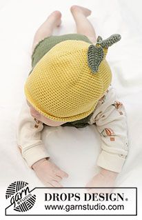 a baby wearing a knitted hat laying on top of a white sheet with the words drops design written below it