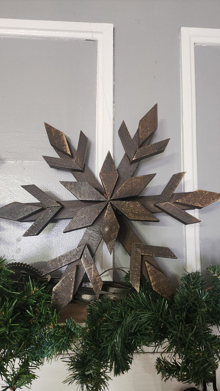 a metal snowflake sitting on top of a mantle