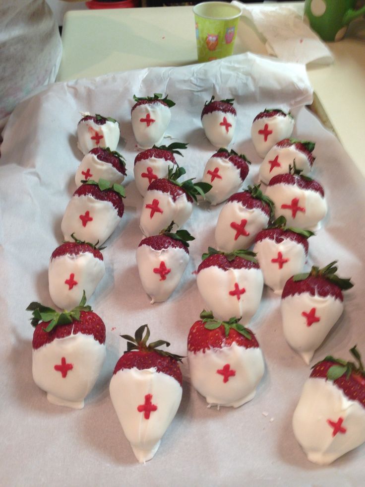 strawberries with white frosting and red crosses on them