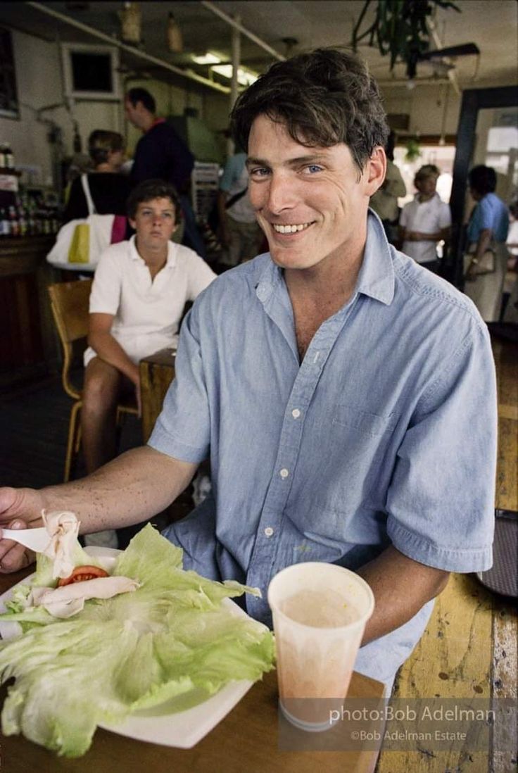 a man sitting at a table with some food in front of him