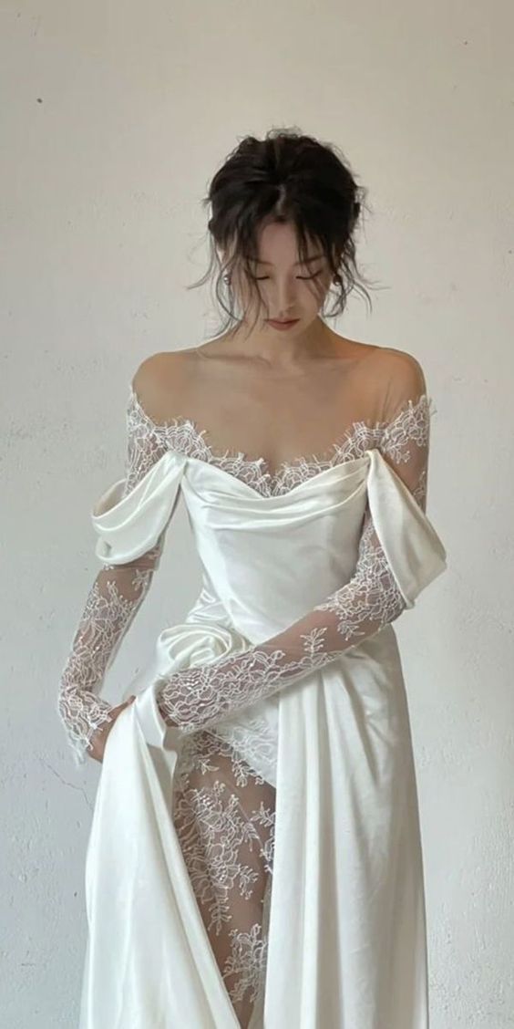 a woman in a white dress with long sleeves and an off the shoulder lace top