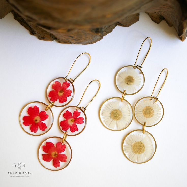 Two pairs of dangle earrings with red verbena flowers and white daises White Resin Earrings For Summer, Bohemian Dangle Earrings With Birth Flower, Bohemian Drop Earrings With Pressed Flowers, Bohemian Summer Jewelry In Flower Shape, Nature-inspired Round Flower Earrings, Bohemian Birth Flower Drop Earrings, Bohemian Pressed Flowers Drop Earrings, Bohemian Dangle Earrings With Pressed Flowers, Nickel Free Flower Earrings For Summer