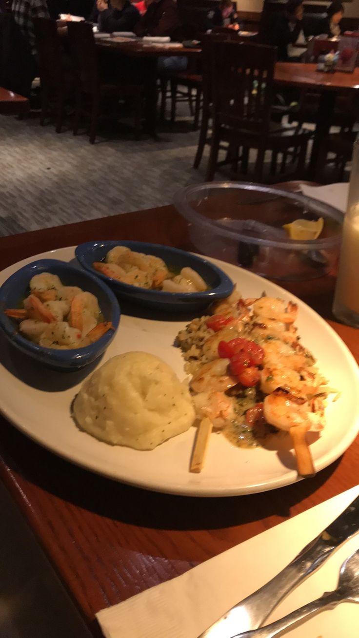 a white plate topped with food on top of a wooden table