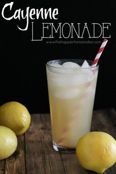 a lemonade drink in a glass next to some lemons