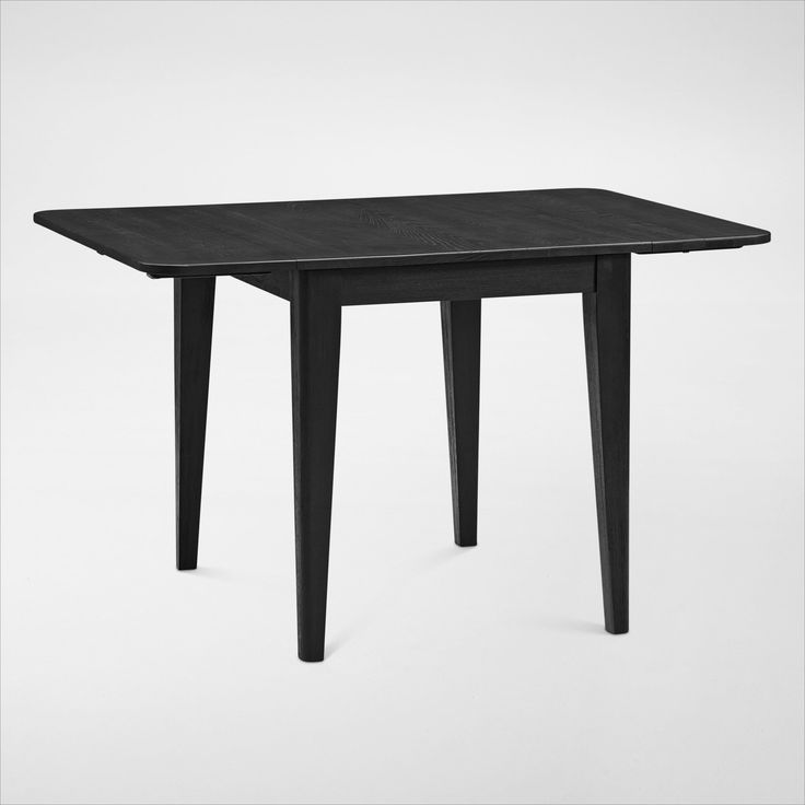 a black table sitting on top of a white floor