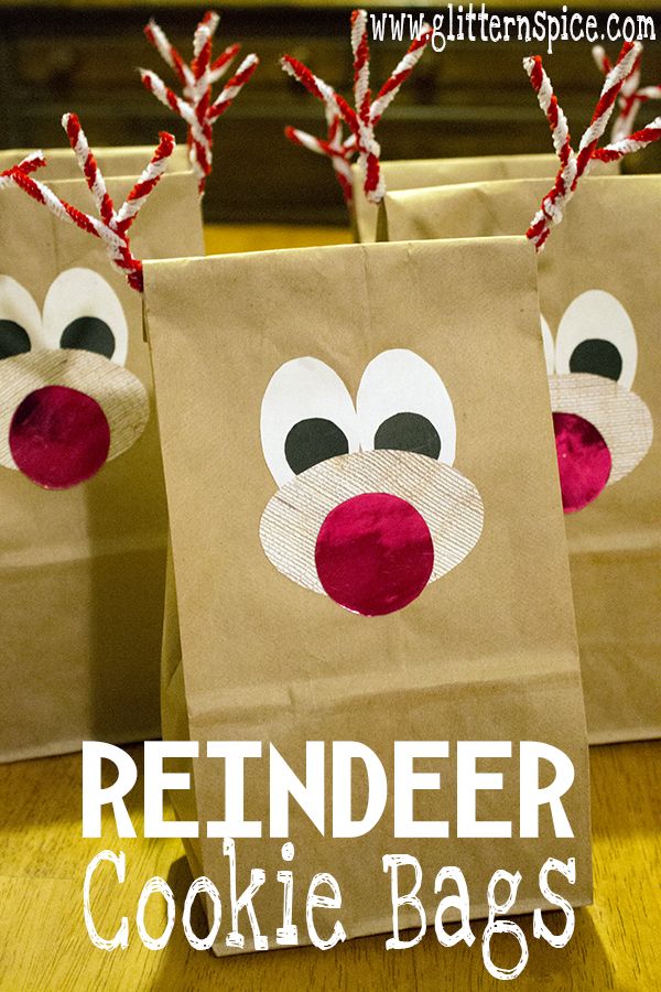 three brown paper bags with reindeer noses on them