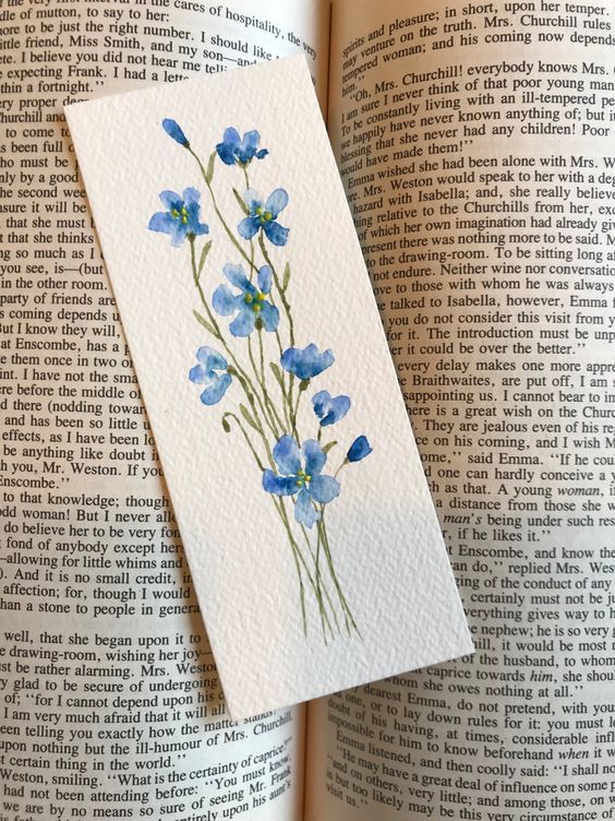 an open book with some blue flowers on it