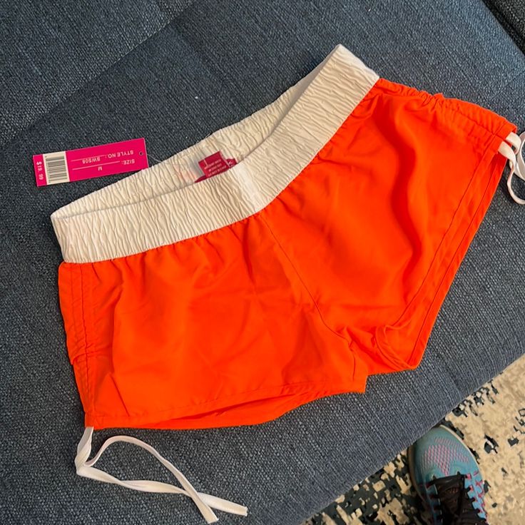 Orange Shorts, Fun For The Beach, With Side Ties Short Bottoms For Summer Beach Activities, Summer Bottoms For Beach Season, Summer Bottoms For Beach Season Activities, Short Beachwear Bottoms For Summer Activities, Casual Bottoms With Built-in Shorts For Summer Activities, White Summer Bottoms For Summer Activities, Sporty Beach Season Bottoms For Summer Activities, Short Swimwear For Summer Activities, Sporty Bottoms For Summer Activities