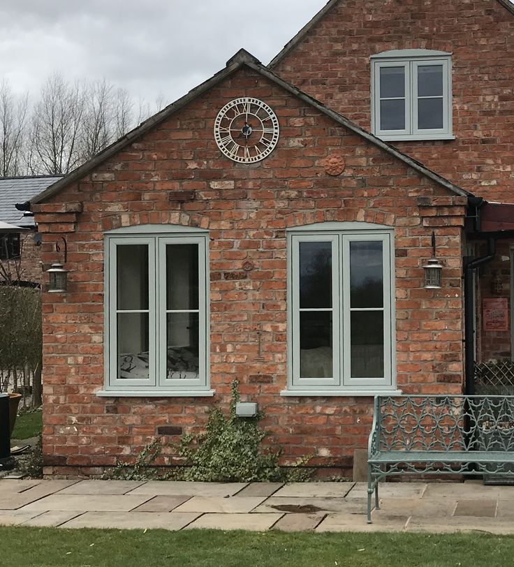 a brick building with a bench in front of it