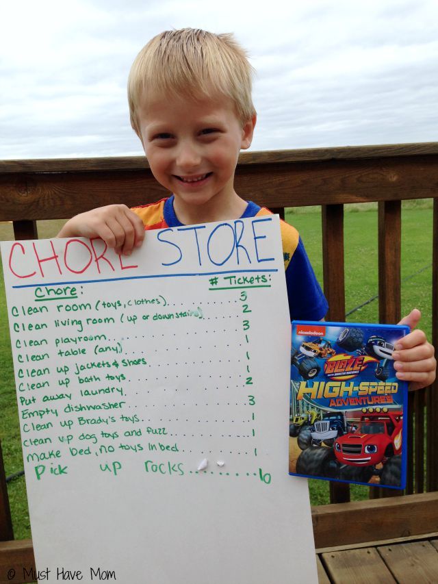 a young boy holding up a sign that says chor store