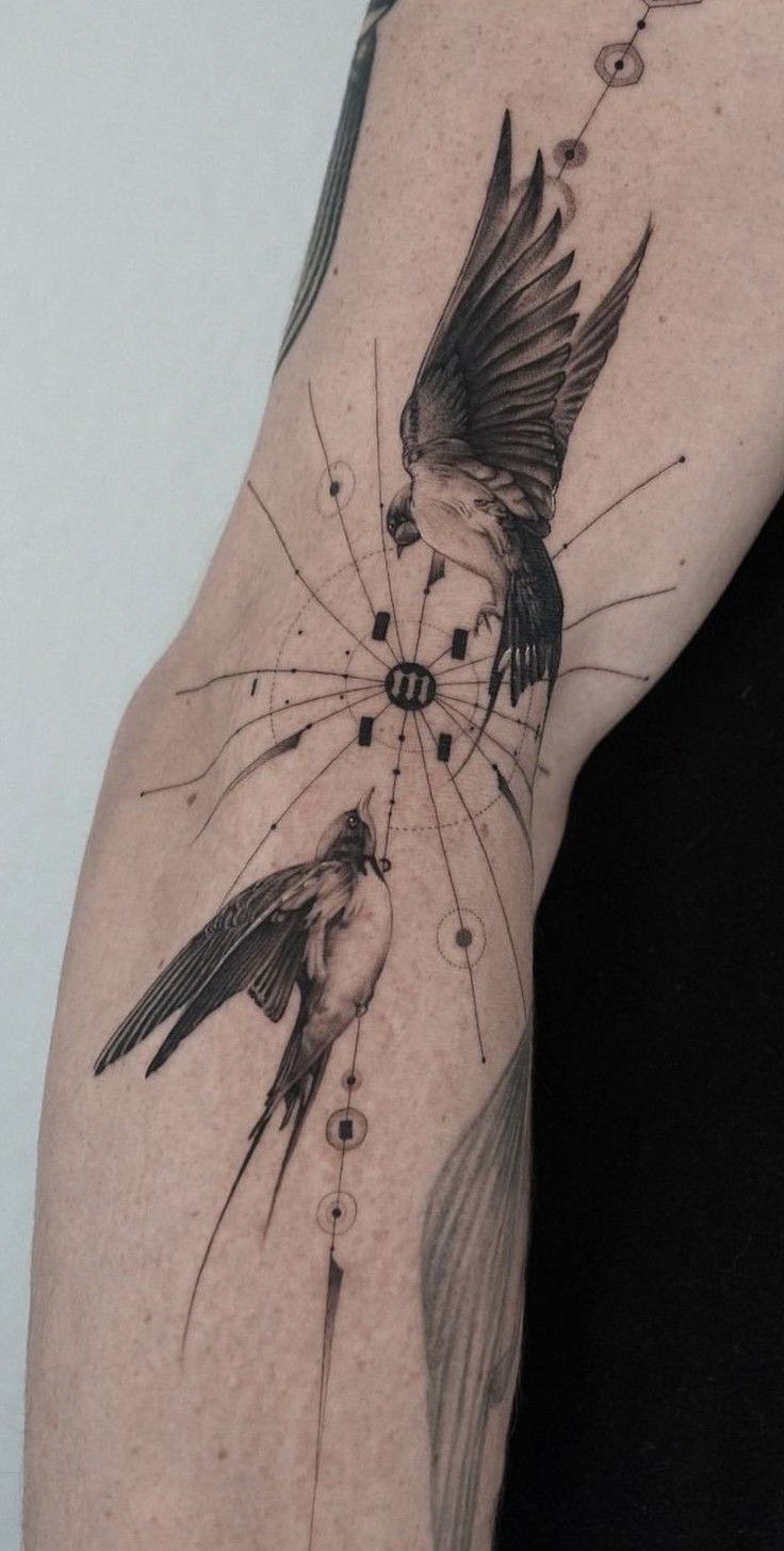 a bird with its wings spread out on the arm