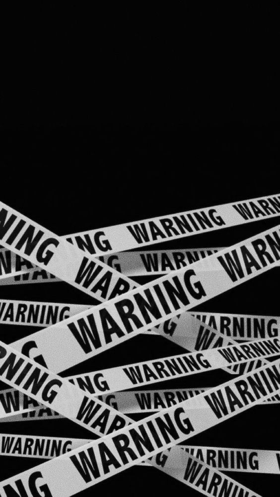 an image of warning stickers on the side of a black background with white letters