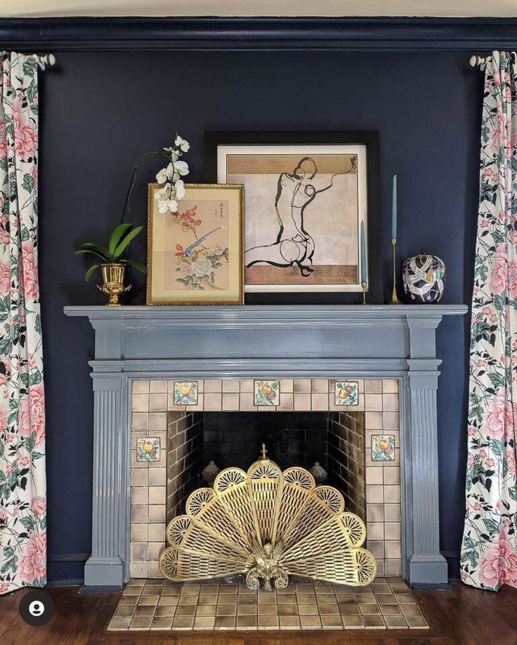 a living room with a fireplace and pictures on the mantle