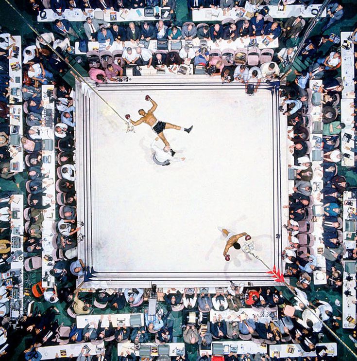 an overhead view of a tennis match with people watching