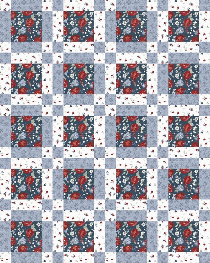 a blue and white quilt with red flowers on it