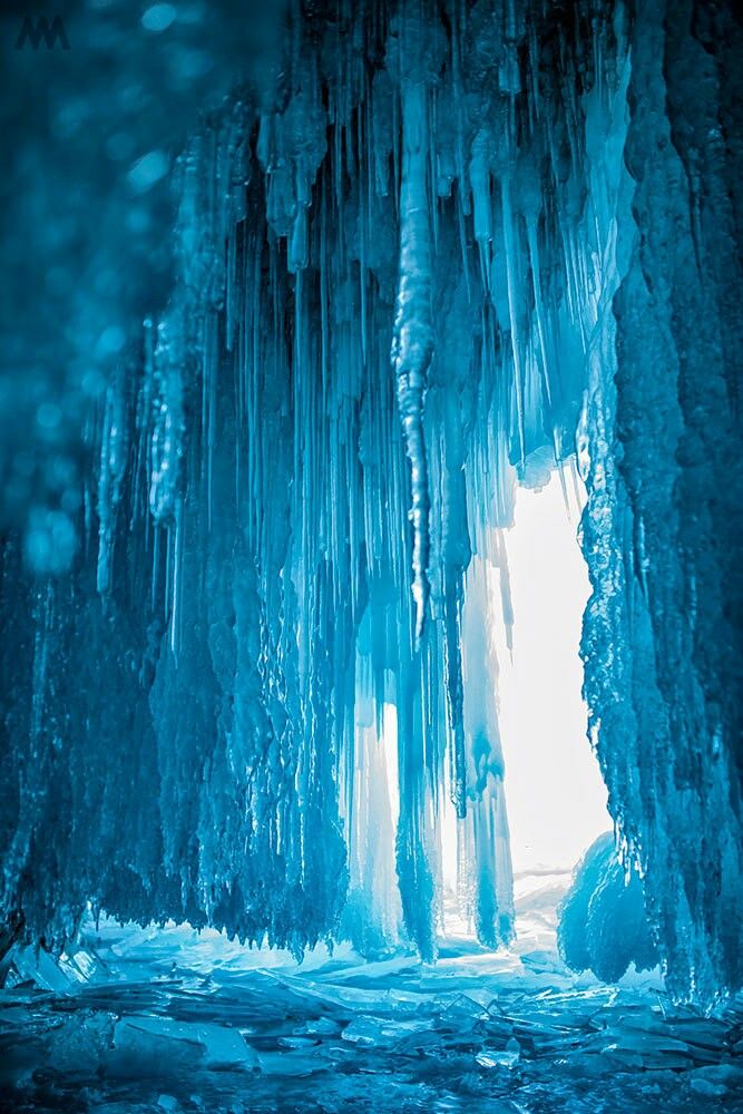 the inside of an ice cave with icicles hanging from it's walls and water running down the side