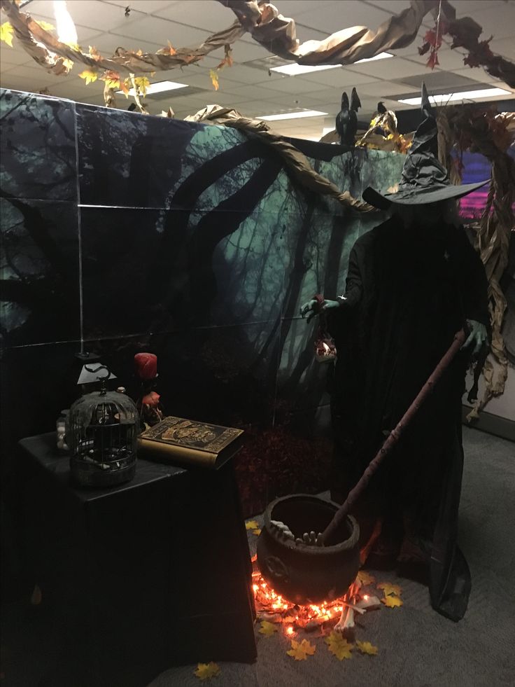 an office decorated for halloween with pumpkins and decorations on the floor, including a wizard's hat