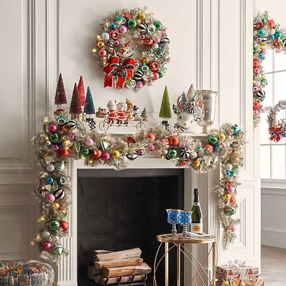 a fireplace decorated with christmas decorations and ornaments