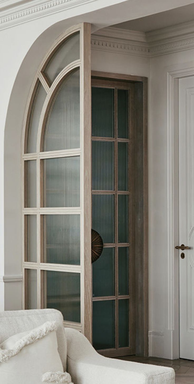 a white couch sitting in front of a doorway