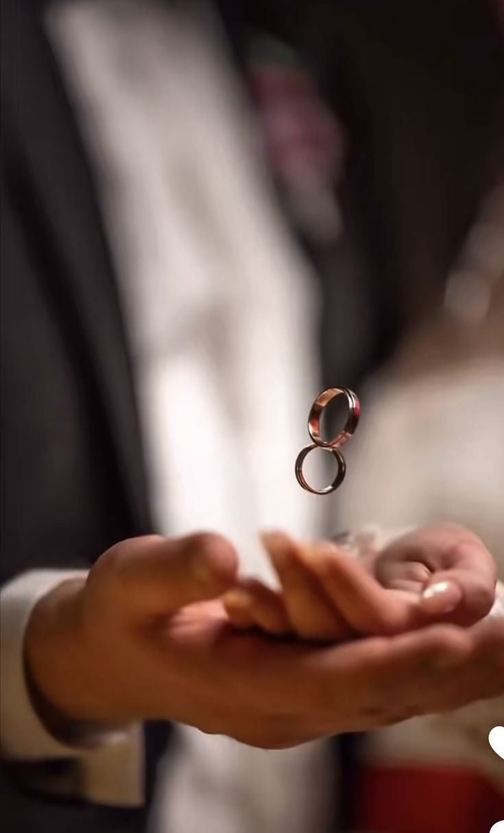 a person holding a ring in their hand