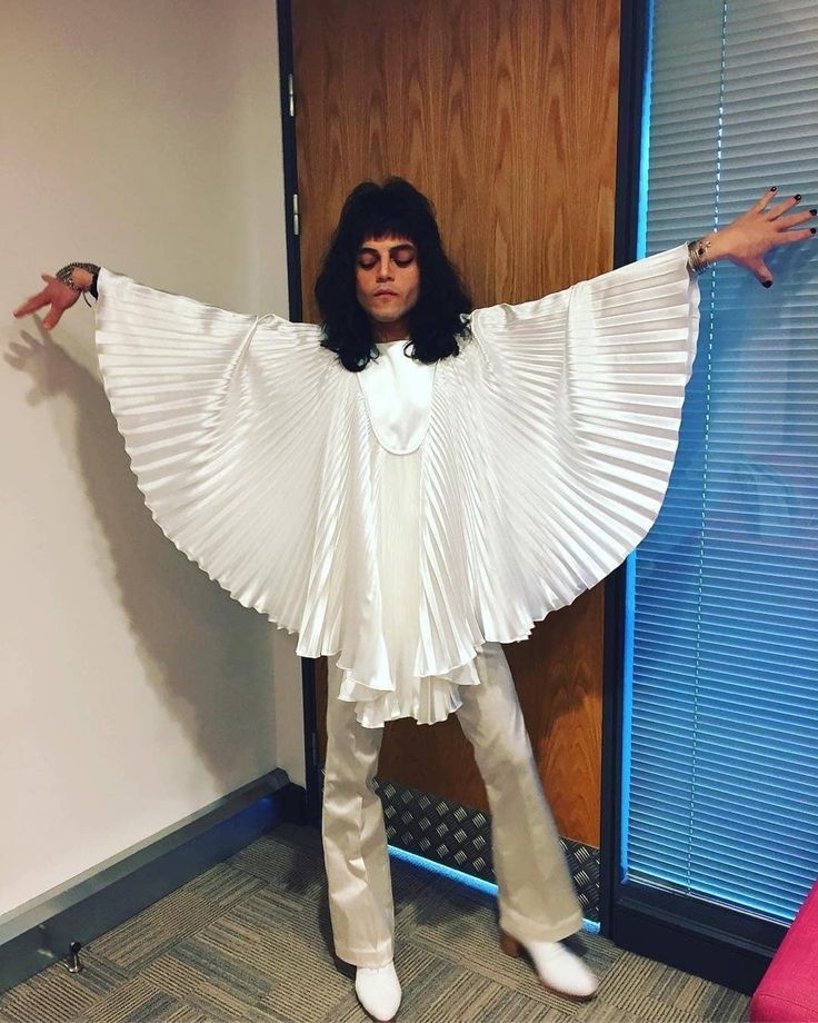 a woman dressed in white poses for the camera