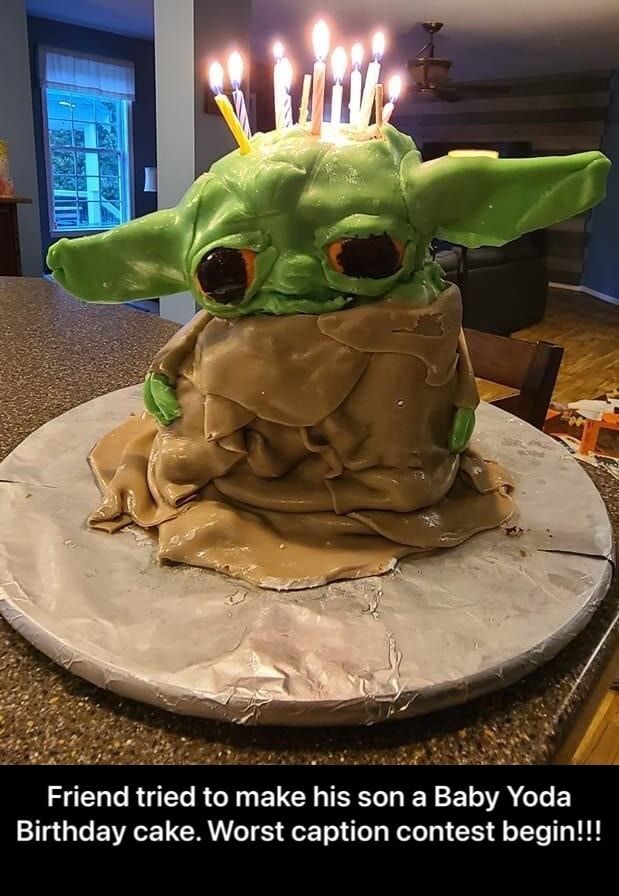 a baby yoda cake with candles on it