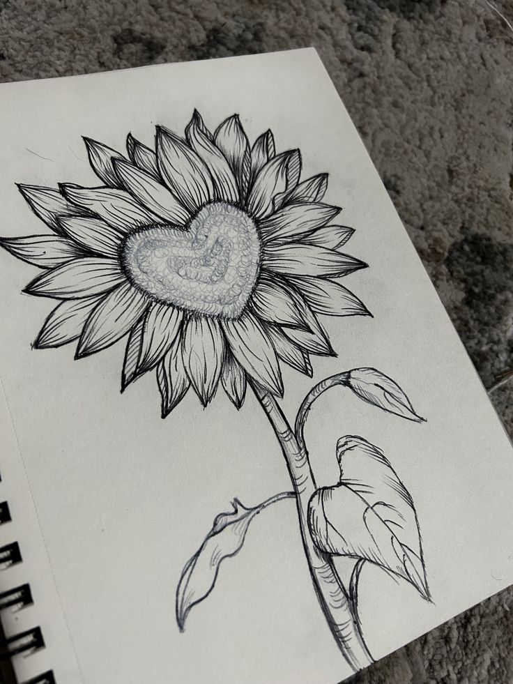 a drawing of a sunflower with a heart on it