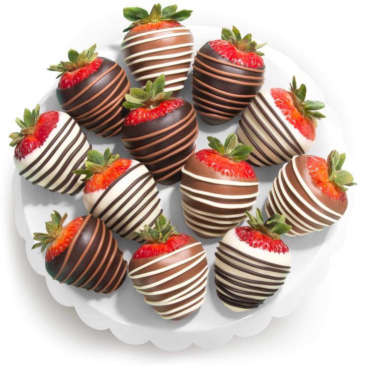 chocolate covered strawberries are arranged on a white platter, ready to be eaten