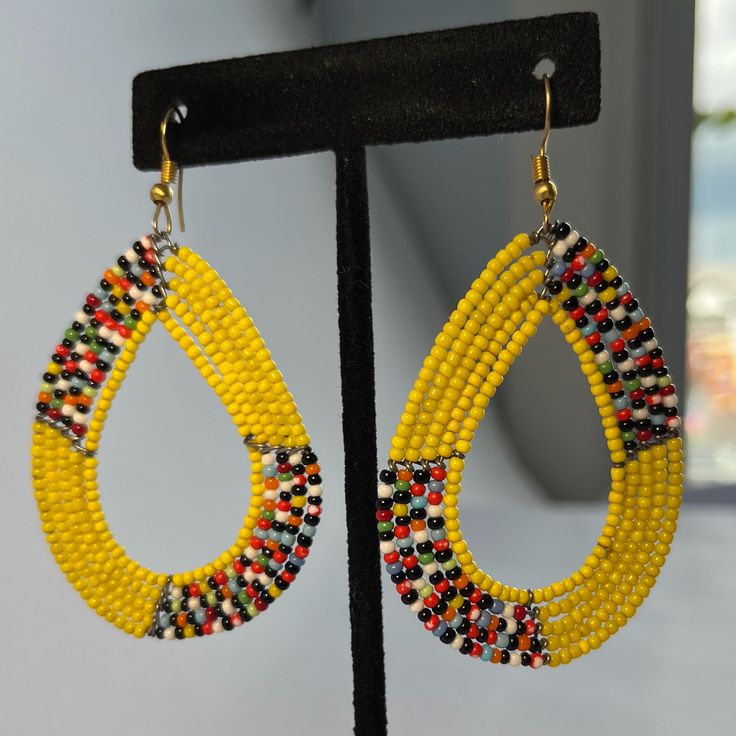 These beautiful earrings are made from beads inspired by the Masai tribe of Kenya. Each earring is handmade Message me to choose your favorite earrings Same price for each Teardrop Earrings With Round Beads, Yellow Beaded Earrings For Pierced Ears As Gift, Adjustable Beaded Teardrop Earrings, Hoop Earrings With Dangling Beads Gift, Unique Teardrop Earrings With Colorful Beads, Yellow Small Hoop Earrings As Gift, Yellow Teardrop Beaded Earrings As Gift, Unique Beaded Dangle Hoop Earrings, Unique Teardrop Jewelry With Colorful Beads