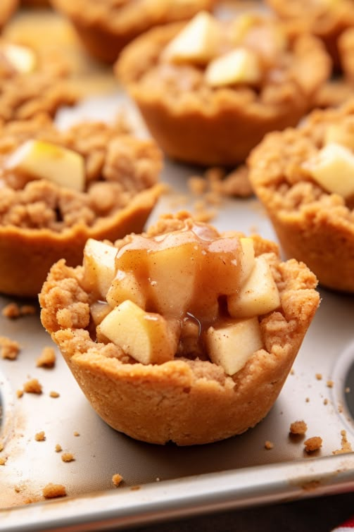 some apple pies sitting on top of a baking pan