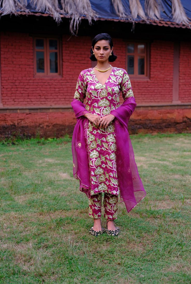 We love a classic, this kurta set returns in a new, vivid print. Crafted in lustrous silk, this kurta set features a V neckline with tailored, cropped trousers. The bold print is hand embroidered to add grandeur. Pair it with our lightweight, sheer organza dupatta dyed in jewelled violet, decorated with intricate zari thread work and beading. We believe customers have a right to know how their product was made. 5.5 meters of Mashru silk sourced from Gujarat has been used for this piece. Hand-block printed in Jaipur. Hand embroidered and manufactured at our workshop in Pune, India. This product is crafted in Jaipur, India using the traditional artisan technique of hand-block printing, and is hand embroidered by our skilled artisans in Pune. Subtle variations in patterns are natural to this Silk Anarkali Pant Set For Diwali, Fitted Zari Work Pant Set For Festive Occasions, Fitted Pant Set With Zari Work For Diwali, Fitted Pant Set With Resham Embroidery And Straight Kurta, Fitted Pant Set With Zari Work For Designer Wear, Fitted Festive Pant Set With Dupatta, Anarkali Silk Set With Straight Kurta, Festive Anarkali Silk Pant Set, Festive Silk Anarkali Pant Set