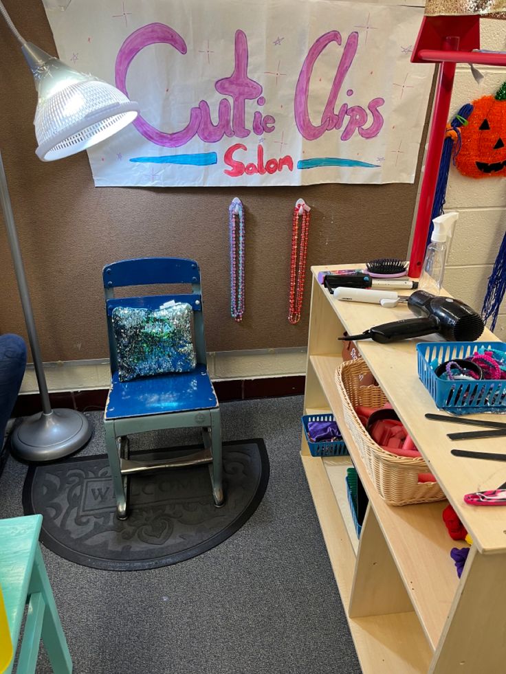 a blue chair sitting in front of a desk with scissors and other items on it