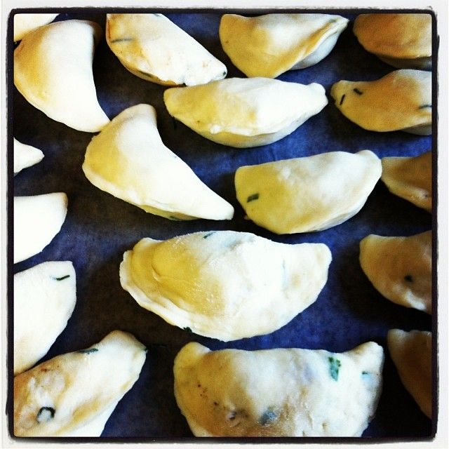 some dumplings are sitting on a baking sheet