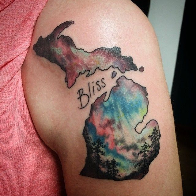 a woman's arm with a watercolor map and the word bliss tattooed on it