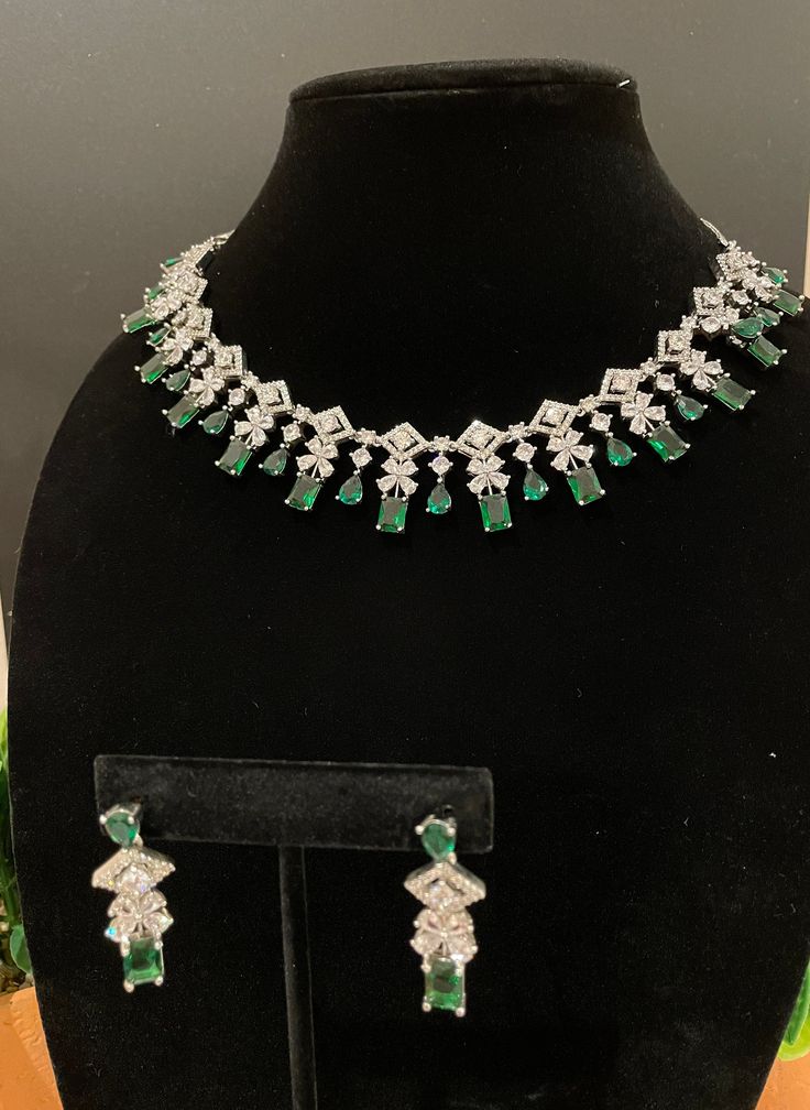 Beautiful and elegant Choker with high quality stones. Comes with a pair of matching earrings in silver and emerald finish. Can pair well with any outfit or dress for a night out! The green stone is amazing quality and is such a beautiful tone. Formal Green Emerald Diamond Necklace, Green Cubic Zirconia Jewelry For Evening, Dazzling Emerald Necklace For Formal Occasions, Formal Emerald Necklace With Elegant Design, Elegant Emerald Necklace For Formal Occasion, Evening Green Cubic Zirconia Jewelry, Cubic Zirconia Jewelry Sets With Stone Setting For Party, Elegant Party Jewelry Sets With Stone Setting, Dazzling Green Emerald Necklace For Formal Occasions