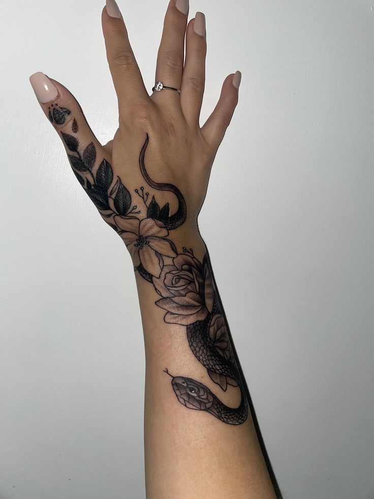 a woman's hand with tattoos on it