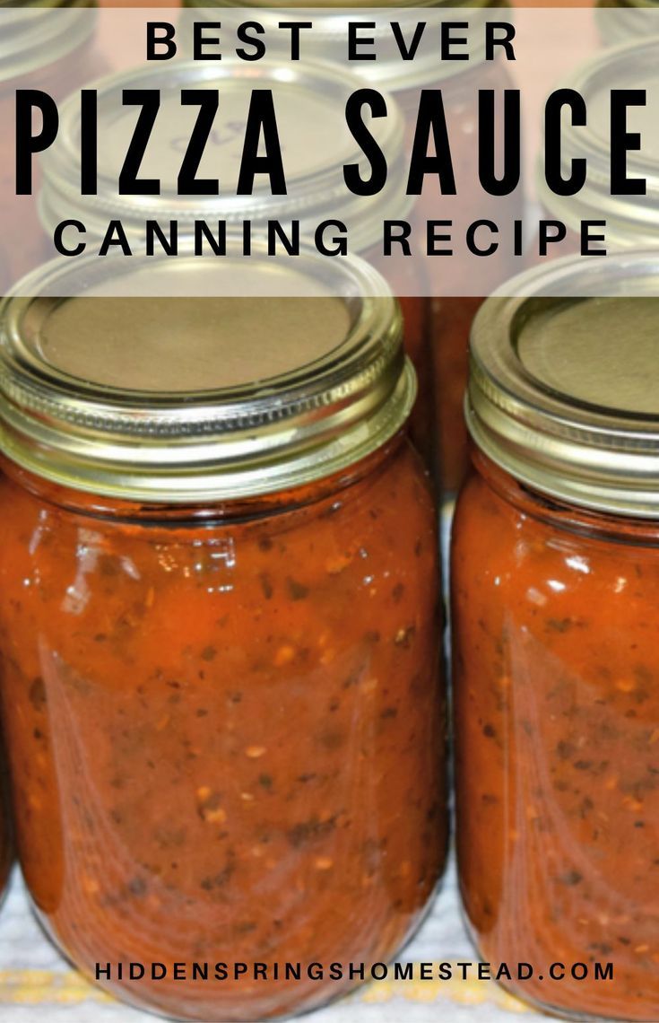 several jars filled with pizza sauce sitting on top of a table