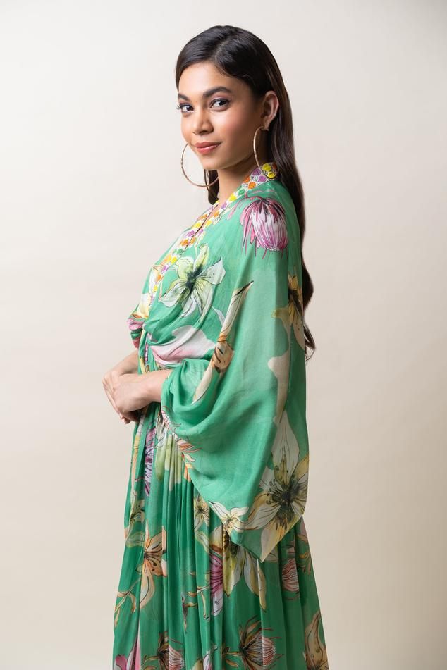 Green chiffon kaftan dress with floral print and sequins hand embroidered placket and neckline. Comes with an inner.
Components: 2
Pattern: Printed, Hand embroidered
Type Of Work: Floral, Sequins
Neckline: V Neck
Sleeve Type: Flared Sleeves
Fabric: Chiffon
Color: Green
Other Details: 
Length : Dress - 57 inches
Occasion: Party - Aza Fashions V Neck Kaftan, Chiffon Kaftan, Dress With Floral Print, Kaftan Dress, Floral Chiffon, Flared Sleeves, Aza Fashion, Sleeve Type, Hand Embroidered