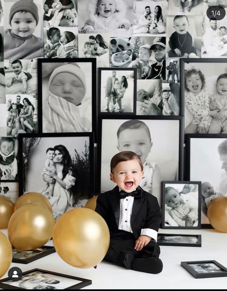 a young boy in a tuxedo is surrounded by balloons and photos on the wall