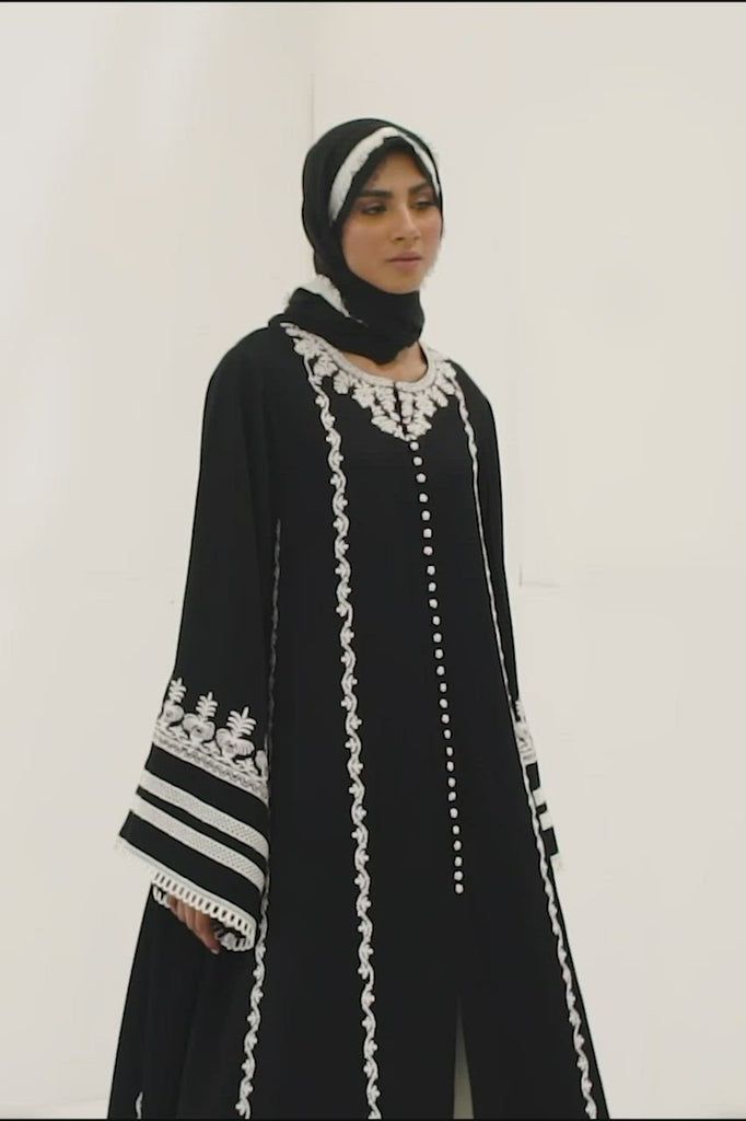 Imaan – Sania Maskatiya International Fitted Embroidered Black Abaya, Elegant Black Georgette Set, Elegant Black Abaya With Floral Embroidery, Elegant Embroidered Black Abaya, Festive Elegant Abaya With Floral Embroidery, Elegant Long Sleeve Abaya With Embroidered Border, Elegant Black Sets For Eid, Elegant Georgette Dress With Embroidered Border, Black Abaya With Floral Embroidery