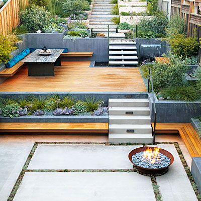 an outdoor fire pit in the middle of a yard