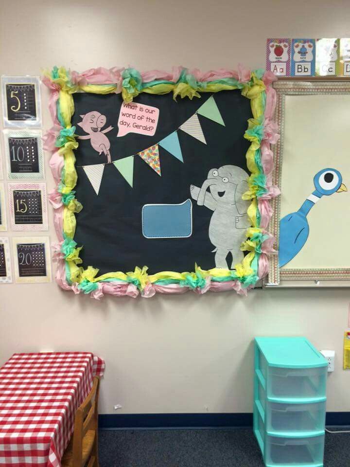 a classroom decorated with an image of a blue bird and some other things on the wall