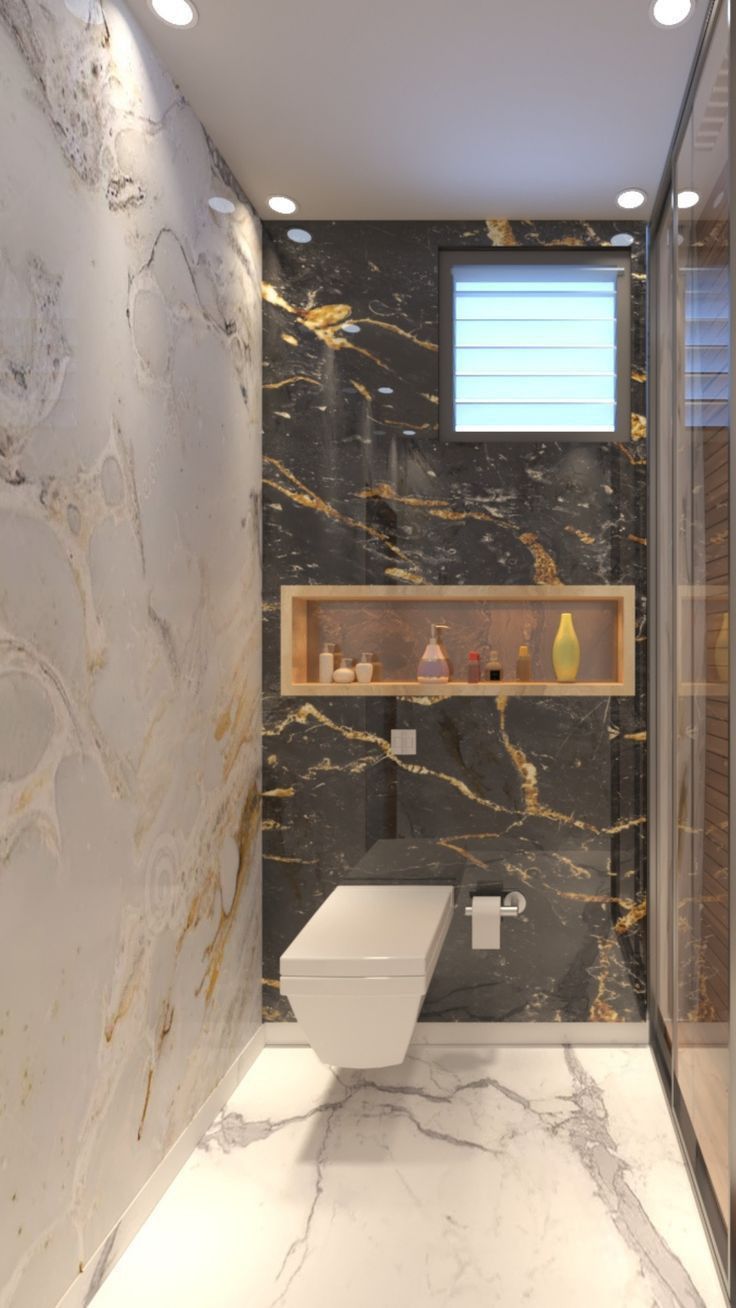 a bathroom with marble walls and flooring in the shower area, along with a toilet