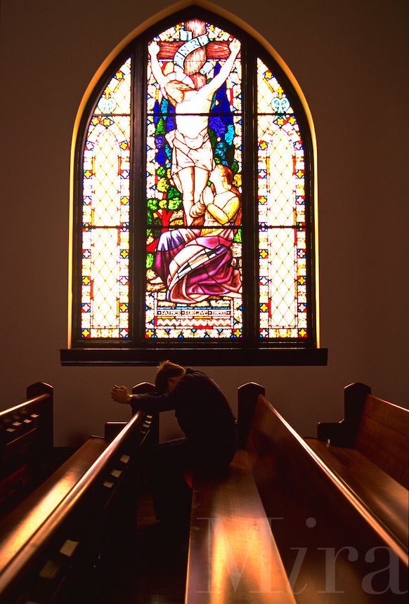 a stained glass window with an image of the crucifix in front of it